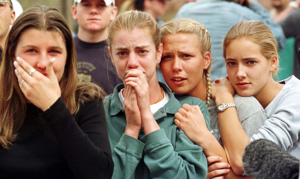 PHOTO: Students from Columbine High School in Littleton, Colo., watch as the last of their fellow students are evacuated from the school building April 20, 1999 following a shooting spree at the school.