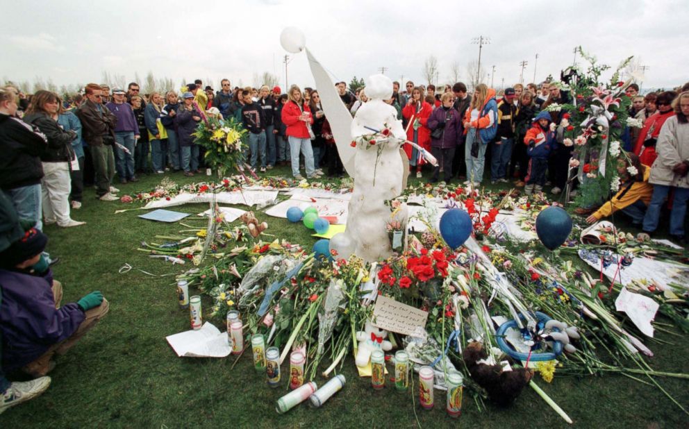 PHOTO: A large crowd circles an angel made of snow leaving flowers during a memorial service, April 25, 1999 in remembrance of the students who were killed in the shooting at Columbine High School in Littleton, Colo. on April 20, 1999. 