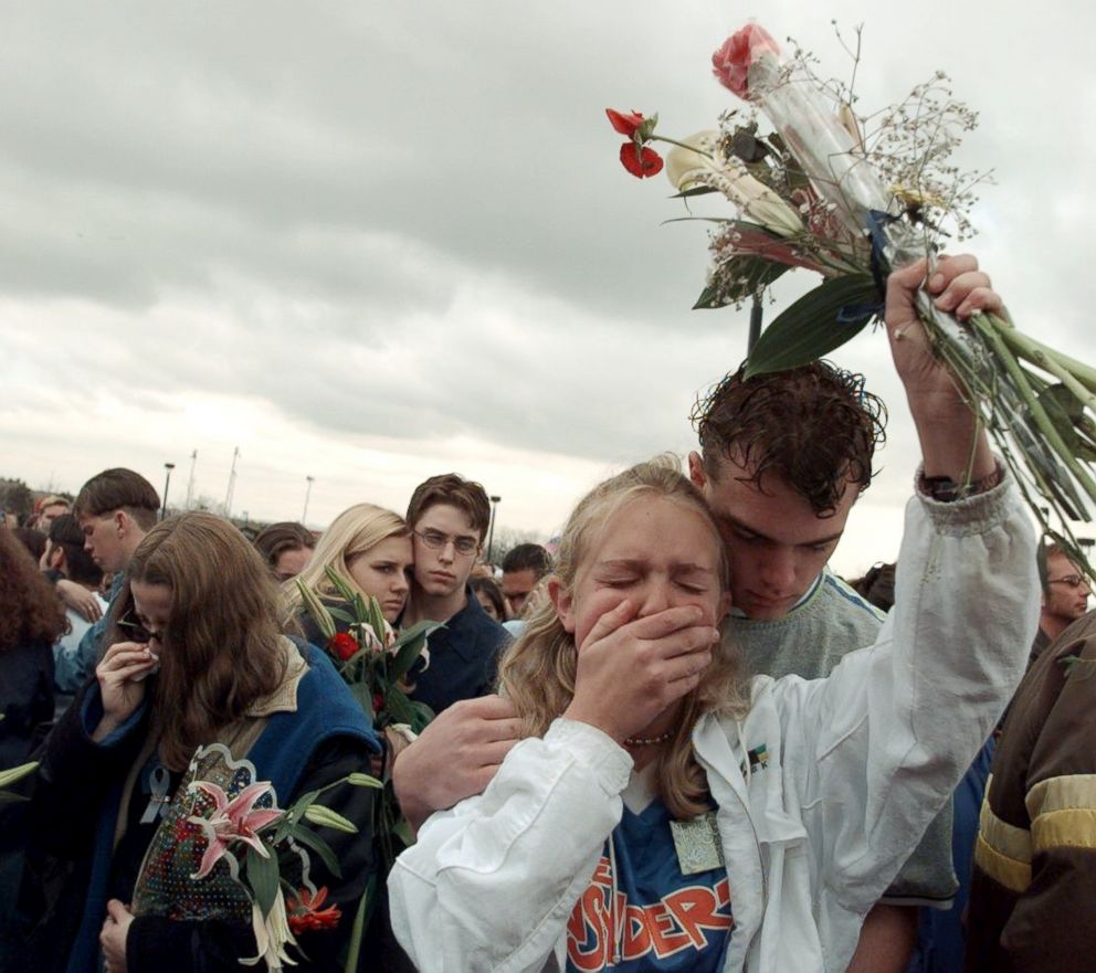 PHOTO: Mourners gather for memorial to victims at Columbine High School on April 25, 1999 in Littleton, Colo., where two teenagers shot to death 12 students and a teacher before killing themselves.