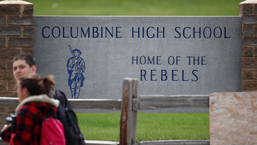 Students leave Columbine High School, April 16, 2019, in Littleton, Colo.