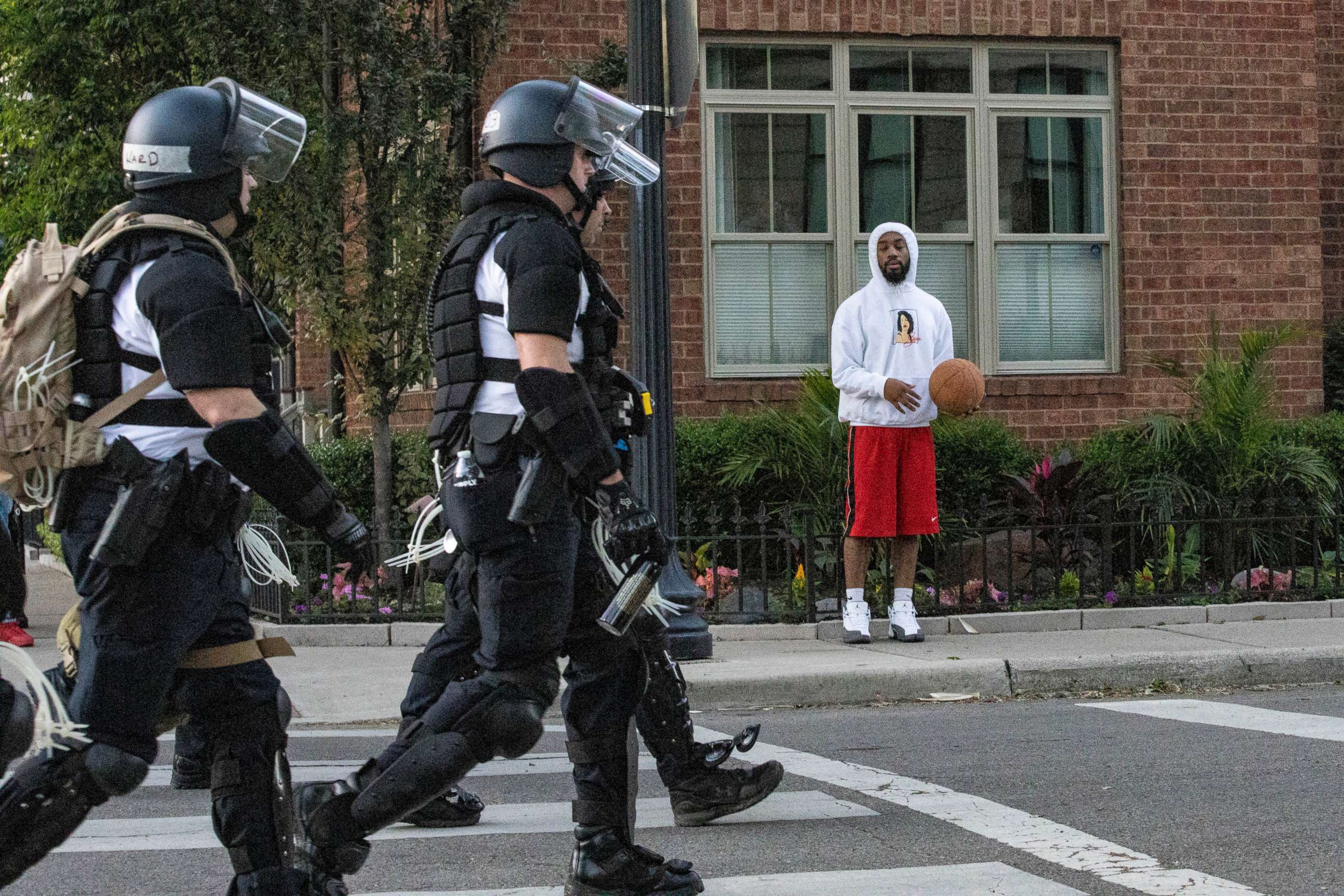 PHOTO: A group of police officers in riot gear walk down the street in Columbus, Ohio, during a demonstration in response to the death of George Floyd at the hands of a Minneapolis police officer, May 30, 2020.