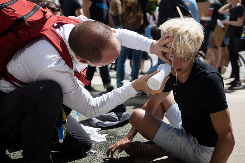 PHOTO: A protester receives first aid after being sprayed with pepper spray by police outside the state house during protests against the death of George Floyd while in police custody, May 30, 2020, in Columbus, Ohio.