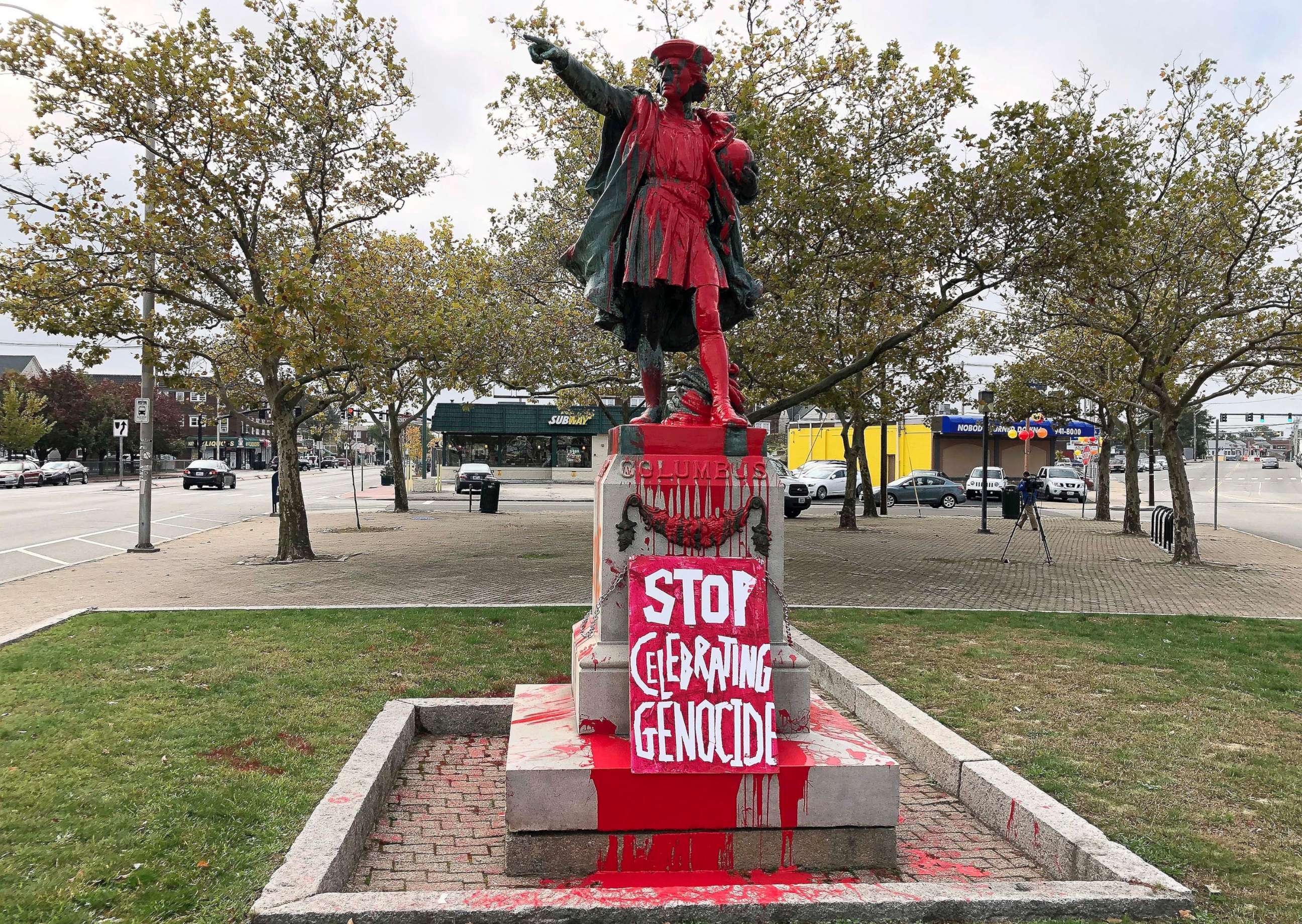PHOTO: A sign reading "stop celebrating genocide" sits at the base of a statue of Christopher Columbus on Oct. 14, 2019, in Providence, R.I.
