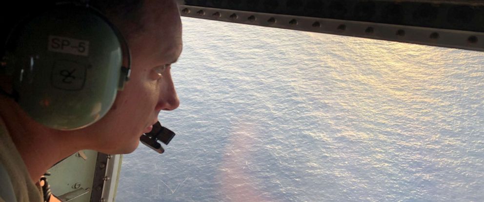PHOTO: Tech. Sgt. Brett Corriveau, 39th Rescue Squadron loadmaster, scans the waters of the Gulf of Mexico from the inside of an HC-130P/N Combat King aircraft for any sign of the missing Airman from the 24th Special Operations Wing.