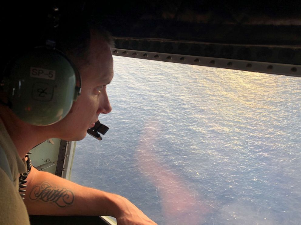 PHOTO: Tech. Sgt. Brett Corriveau, 39th Rescue Squadron loadmaster, scans the waters of the Gulf of Mexico from the inside of an HC-130P/N Combat King aircraft for any sign of the missing Airman from the 24th Special Operations Wing.