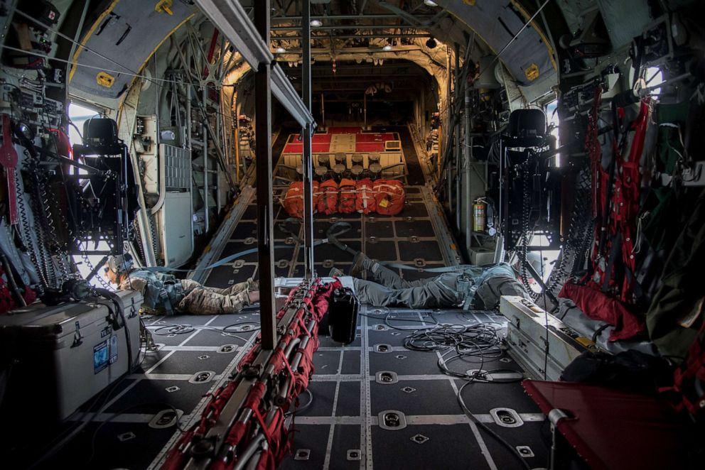 PHOTO: Master Sgt. Marcus Hildebrand and Tech. Sgt. Patrick Englishby, 39th Rescue Squadron loadmasters, scan the waters of the Gulf of Mexico.