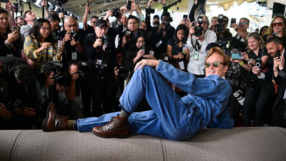 PHOTO: Host Conan O'Brien lies on the carpet as he participates in the 98th Oscars arrivals carpet roll out in Hollywood, Calif., March 11, 2026.