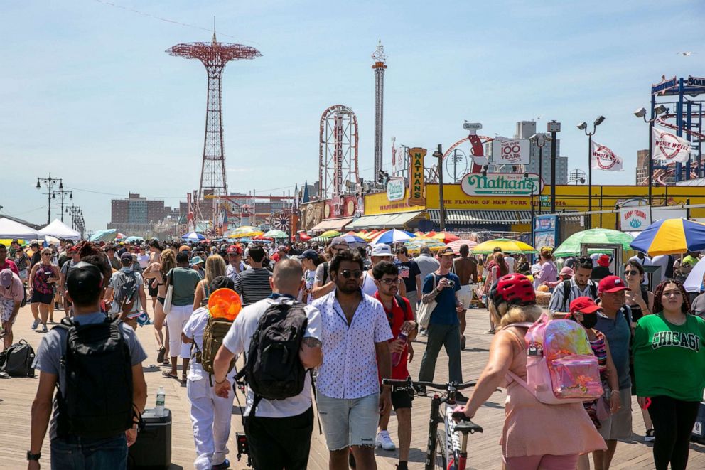 PHOTO: People gather on the boardwalk at Coney Island on the Fourth of July in New York, July 4, 2022.