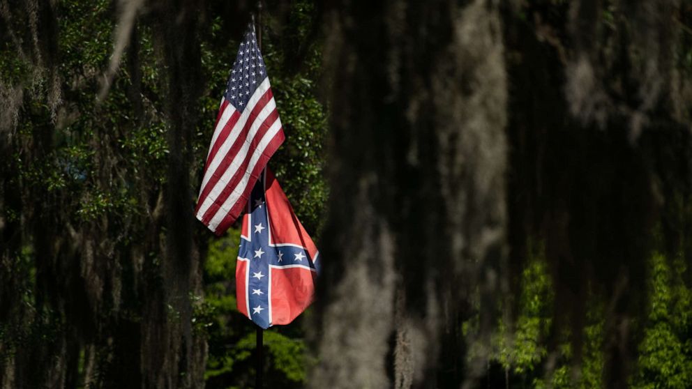 PHOTO: American and Confederate flags fly at a residence, May 7, 2020, in Brunswick, Georgia.