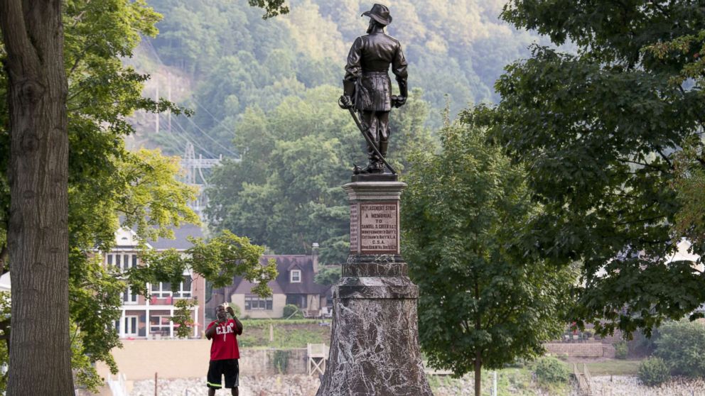 A passerby stops to take a picture of the statue of Confederate General Thomas Stonewall Jackson at the West Virginia State Capitol Complex on Aug. 16, 2017 in Charleston, W.V.