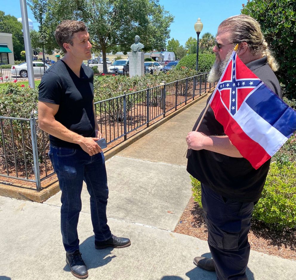 PHOTO: ABC News Correspondent Will Carr talks to Bruce Roberts about his support for Confederate monuments and the Mississippi flag, in Gulfport, Miss., June 16, 2020.
