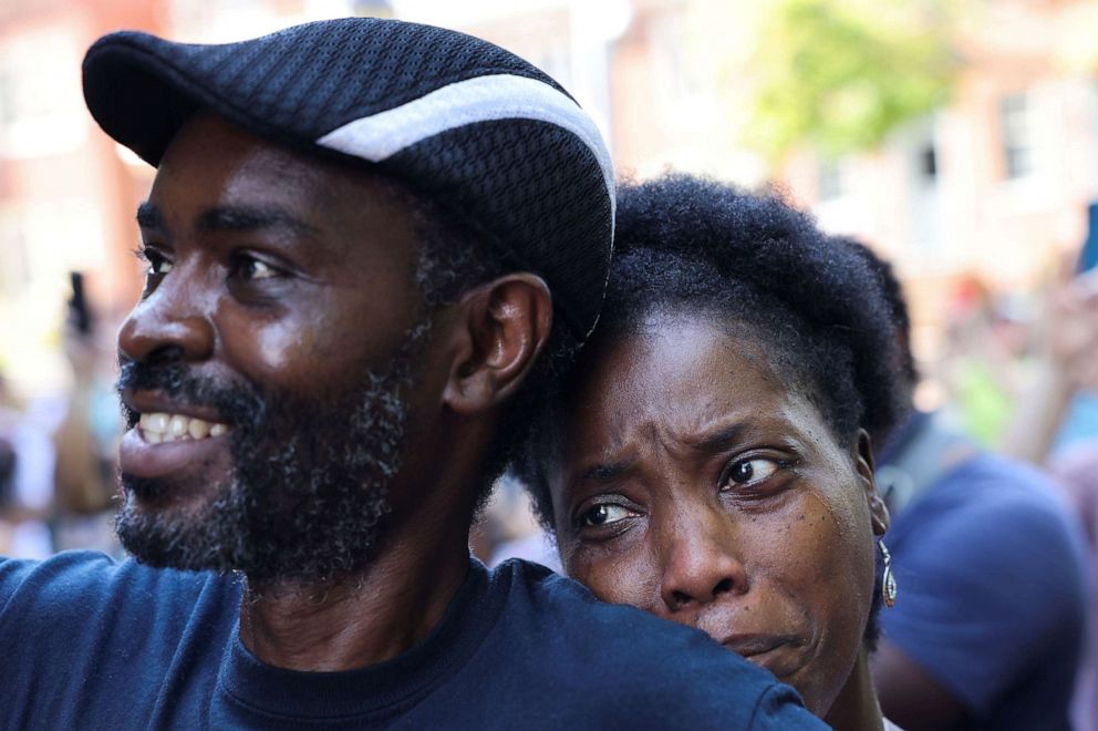 PHOTO: Tanya and Evance Chanda from Mechanicsville look on as a statue of Confederate General Thomas "Stonewall" Jackson is removed after years of a legal battle over the contentious monument, in Charlottesville, Va., July 10, 2021.