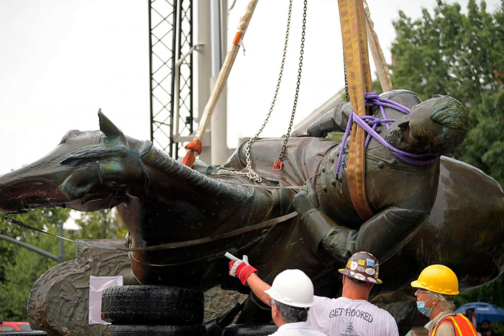 PHOTO: The statue of confederate general Stonewall Jackson is loaded onto a flat bed trailer after a crane lifted the statue off its base located at the intersection of Monument Avenue and Arthur Ashe Blvd in Richmond, Va., July 1, 2020.