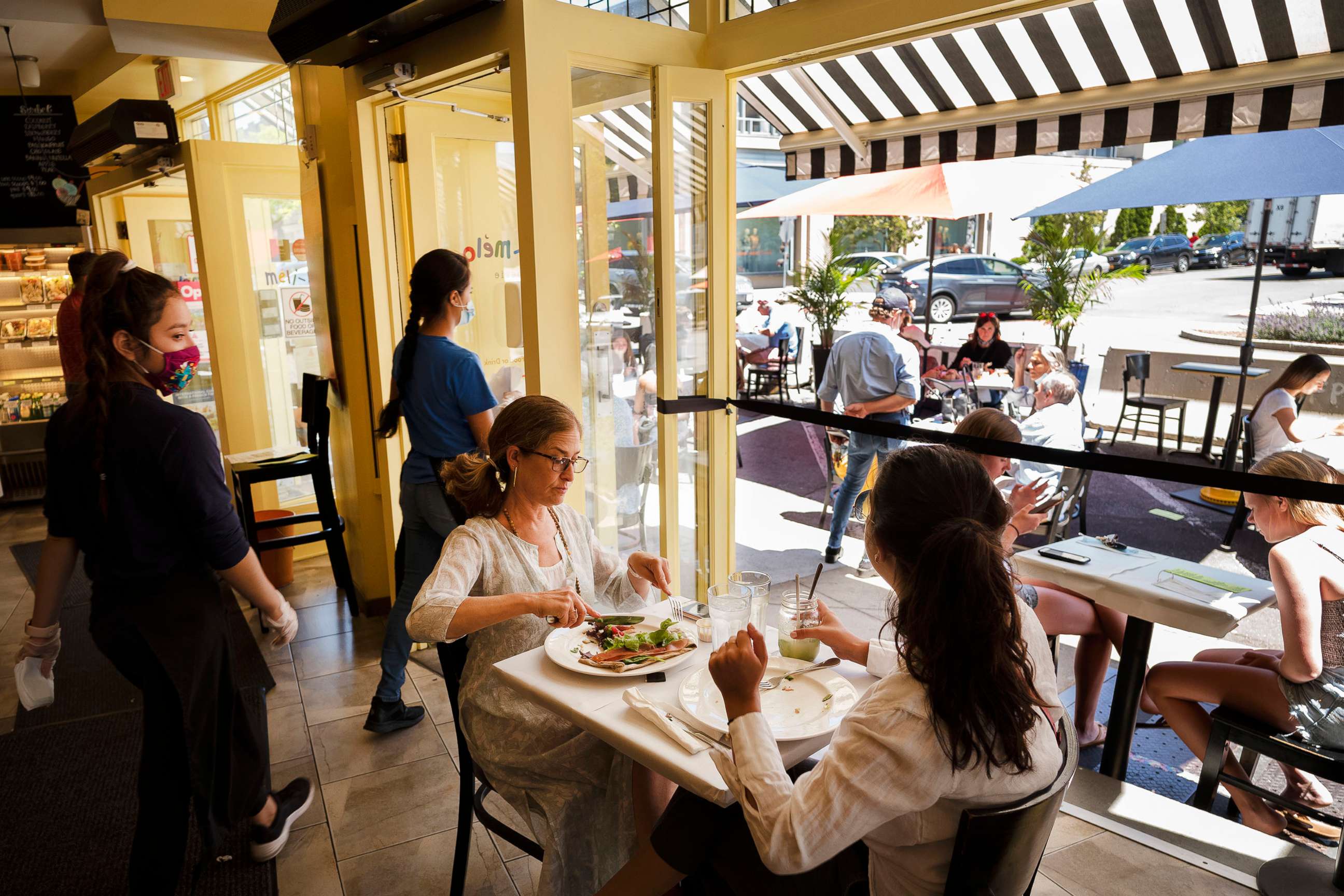 PHOTO: People eat lunch at Meli-Melo Creperie, Juice Bar & Cafe, June 17, 2020, in Greenwich, Conn.