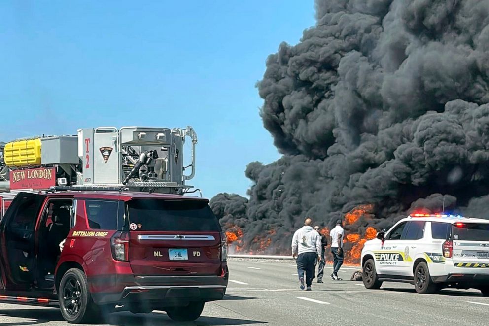 PHOTO: This photo provided by Angelique Feliciano shows firefighters and police responding after a crash involving a fuel truck and a car sparked a fire on the Gold Star Bridge between New London and Groton, Conn., on April 21, 2023.