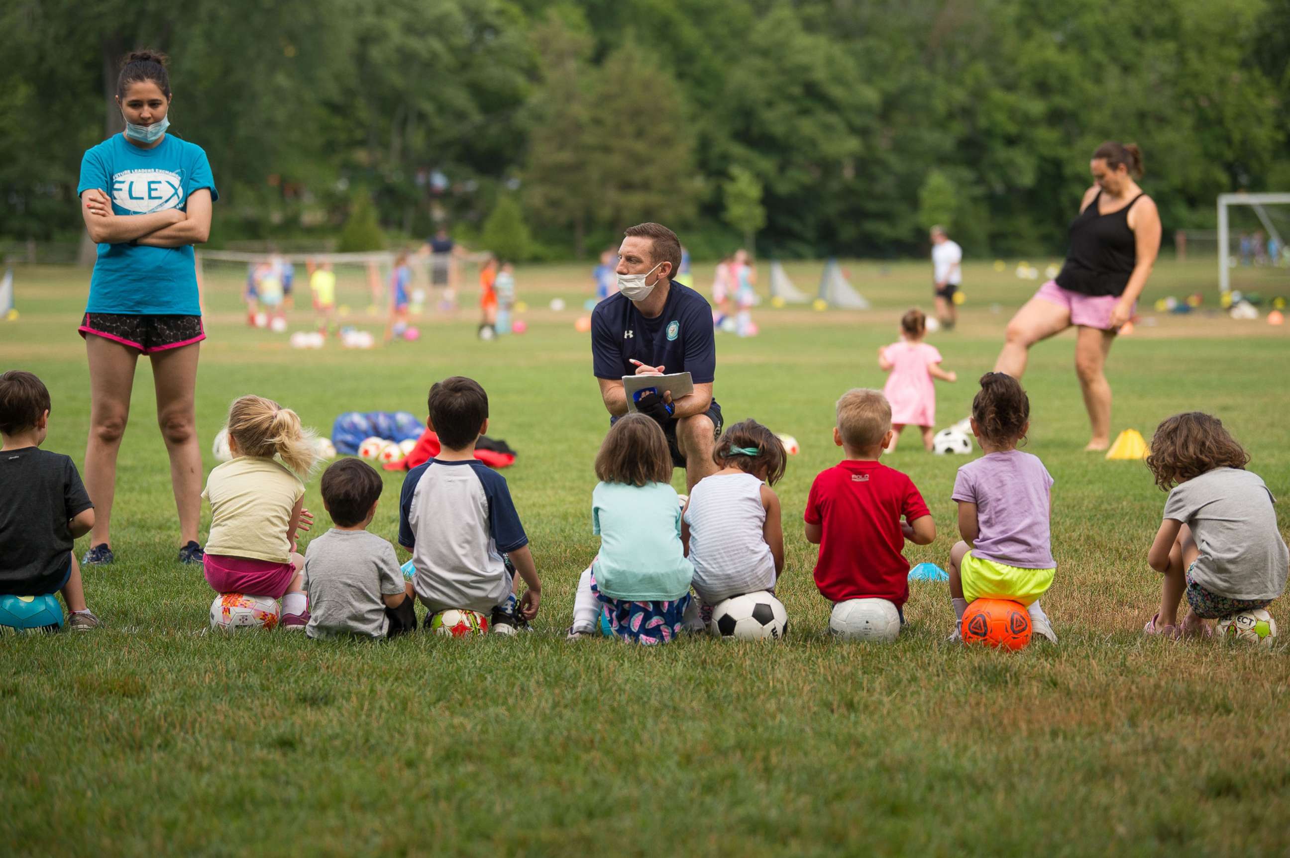 PHOTO: A coach wears a face masks during the opening of summer soccer camps in Darien, Conn., July 1, 2020.