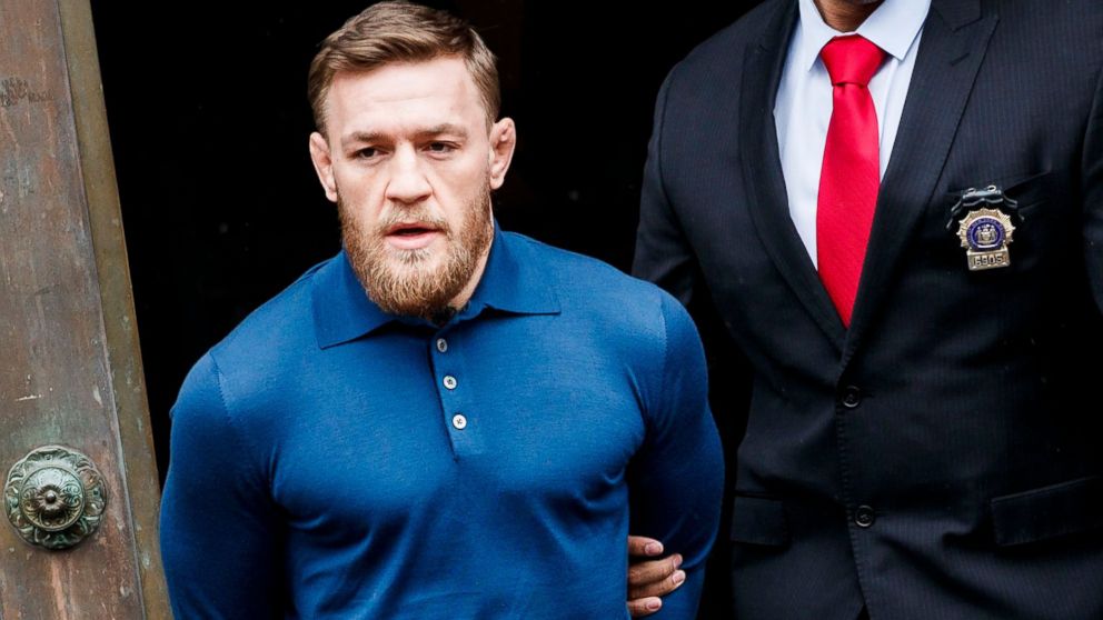  Mixed martial arts fighter Conor McGregor is escorted from a New York City police precinct after he turned himself and was arrested and charged with three counts of assault and one count of criminal mischief in Brooklyn, N.Y., April 6, 2018.
					