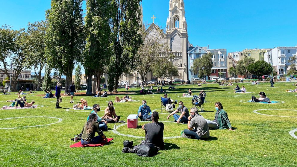 PHOTO: People practicing social distancing enjoy the weather at Washington square park in San Francisco, July 31, 2020.