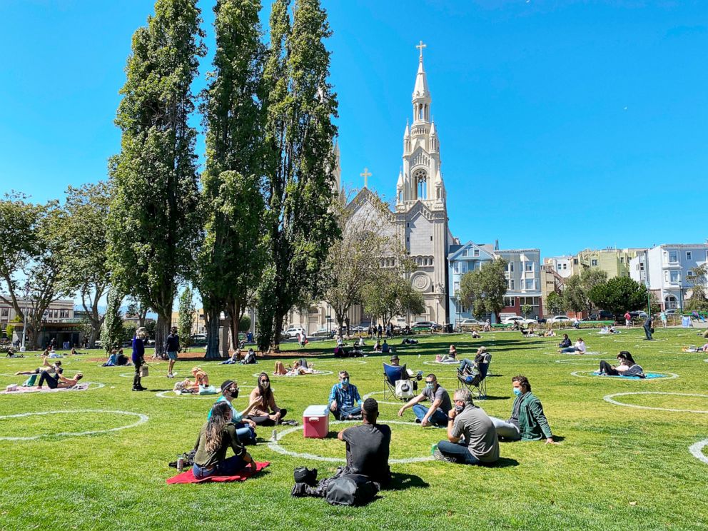 PHOTO: People practicing social distancing enjoy the weather at Washington square park in San Francisco, July 31, 2020.