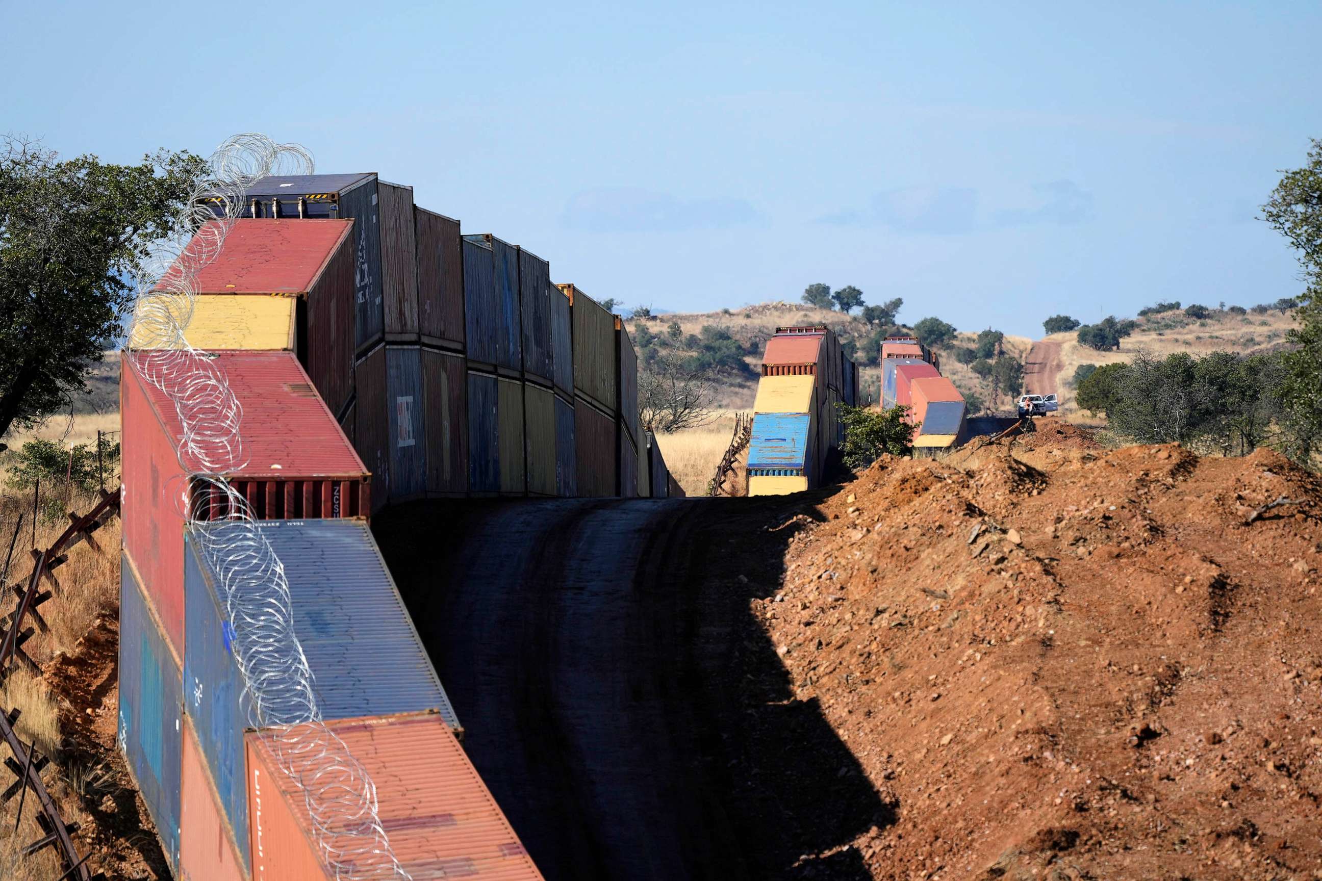 PHOTO: A long row of double-stacked shipping contrainers provide a new wall between the United States and Mexico in the remote section area of San Rafael Valley, Ariz., Dec. 8, 2022.