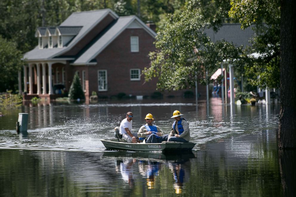 PHOTO: People navigate floodwaters caused by Hurricane Florence near the Waccamaw River, Sept. 23, 2018, in Conway, South Carolina.