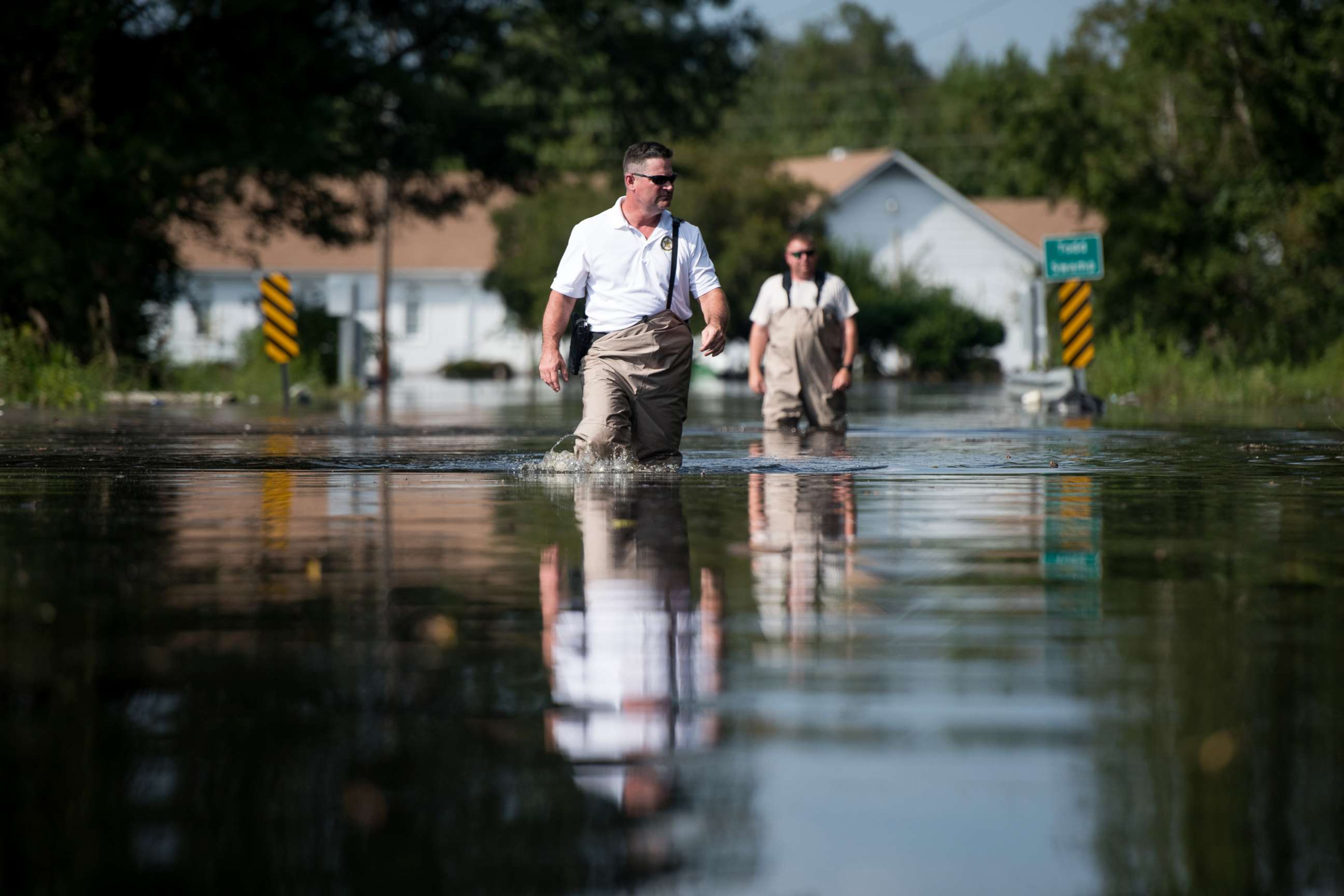 PHOTO: A Department of Natural Resources officer, left, and a South Carolina Law Enforcement agent walk through floodwaters caused by Hurricane Florence near the Todd Swamp, Sept. 21, 2018, in Longs, South Carolina.