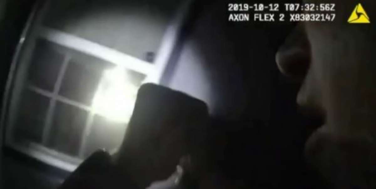 PHOTO: A police officer is seen in bodycam footage shining a flashlight moments before shooting into a window, striking a woman and killing her.