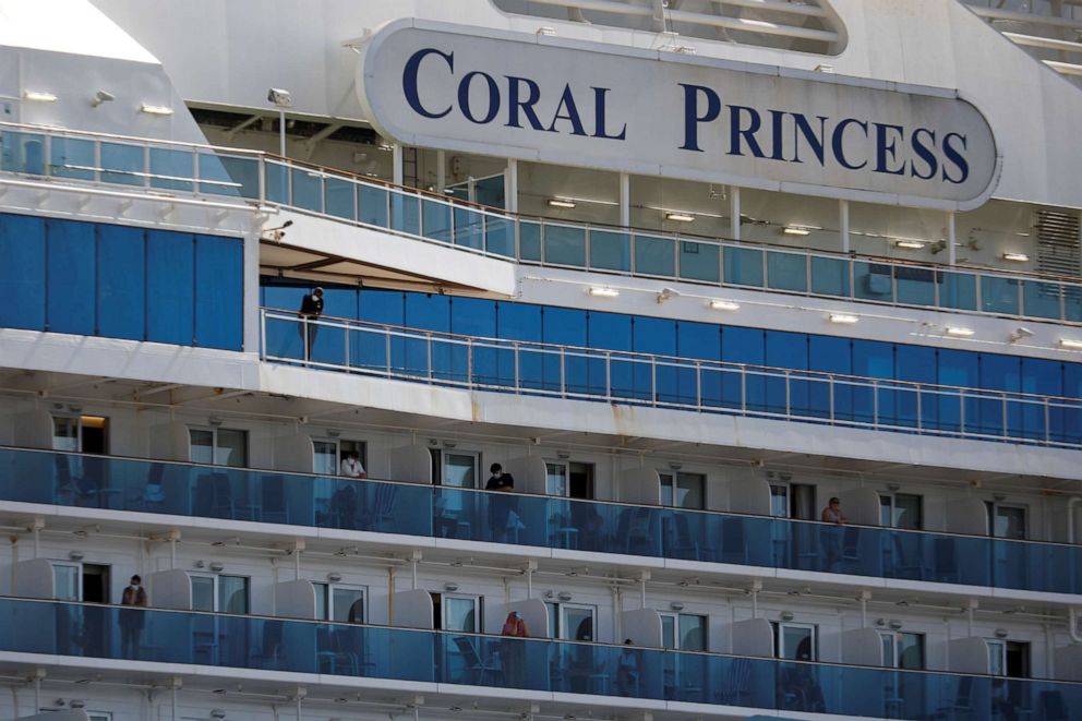 PHOTO: Passengers are seen aboard the Coral Princess ship, of Princess Cruises fleet, with patients affected by COVID-19, as it docks at Miami Port, in Miami on April 4, 2020.