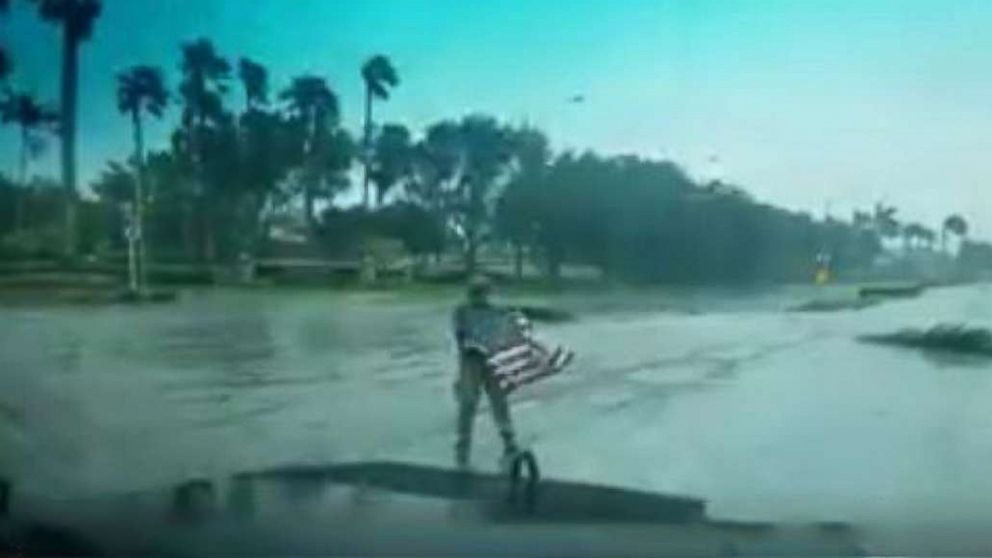 PHOTO: First responder Joseph Schiavo picks up a fallen flag while patrolling in Coral Springs, Florida, after Hurricane Irma hit the area, Sept. 10, 2017.