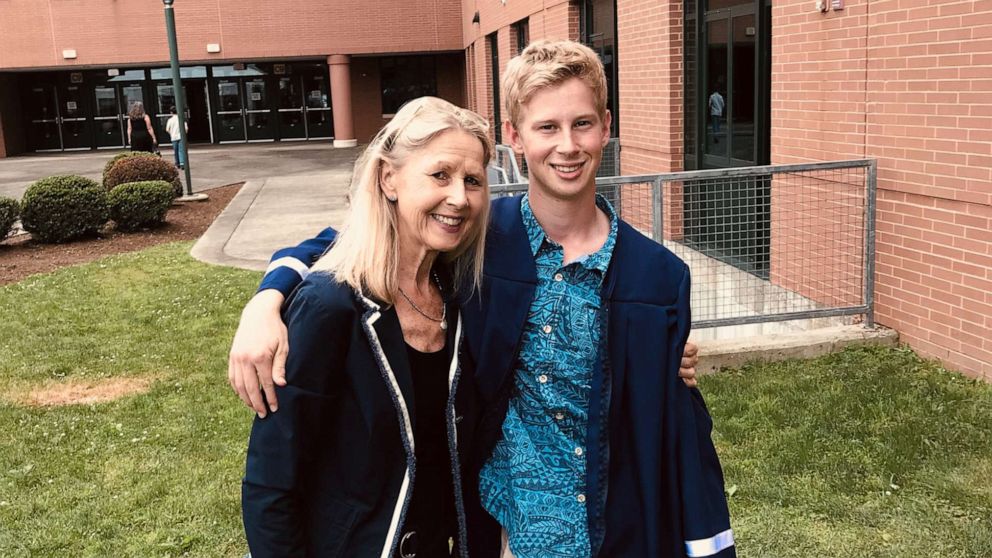 PHOTO: Corey Hausman poses with his mother, Nanette Hausman, at his High School graduation in 2018.