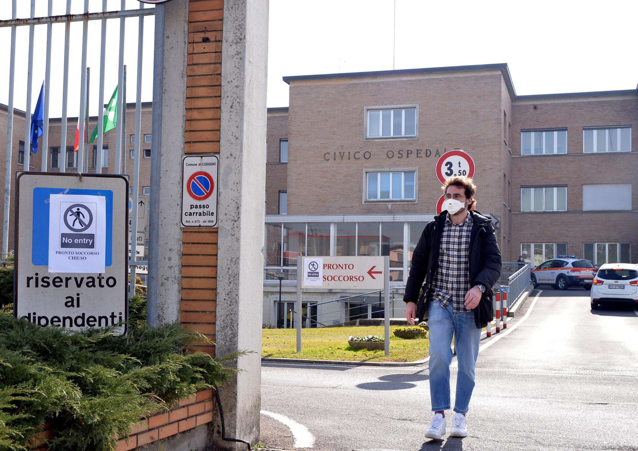 PHOTO: A person wearing a face mask walks out of an entrance gate to the Codogno Civic Hospital, where the emergency room was closed as a precautionary measure, in Codogno, near Lodi, northern Italy on Feb. 21 2020. 