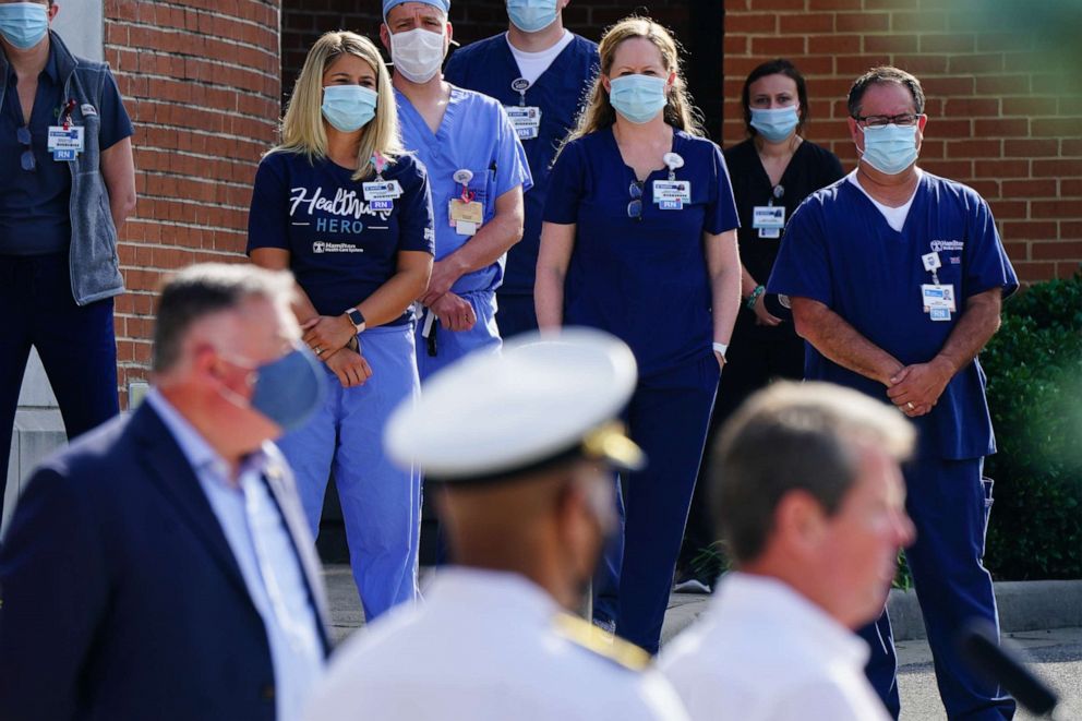 PHOTO: Hamilton Health Care medical staff listen while Brian Kemp, governor of Georgia speaks during a 'Wear A Mask' tour stop in Dalton, Ga., July 2, 2020.