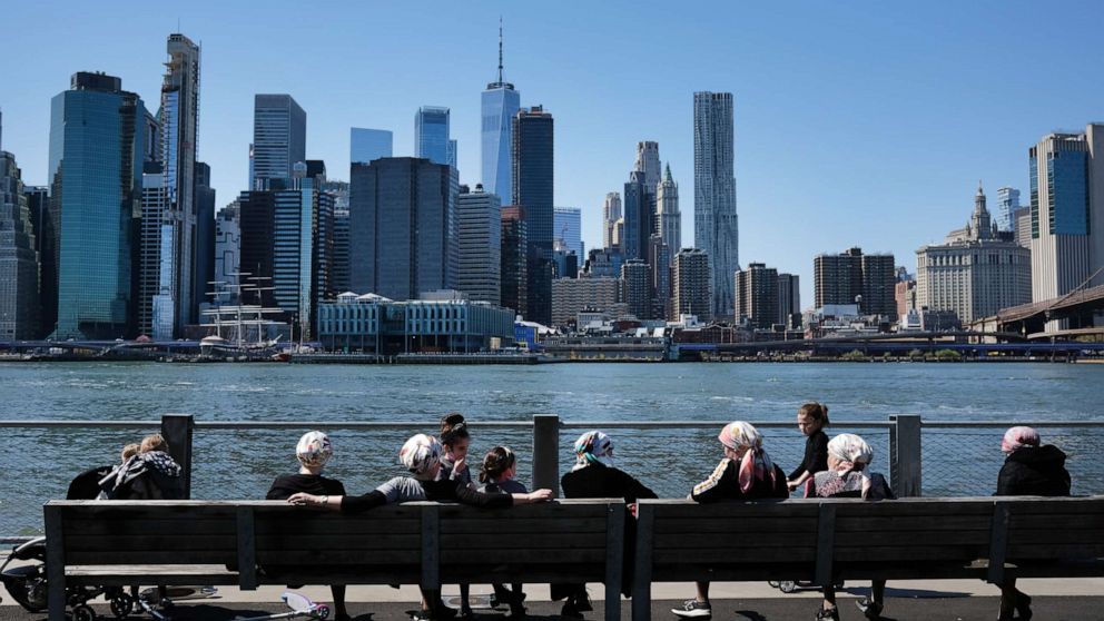 PHOTO: People enjoy a spring afternoon in Brooklyn Bridge Park on April 28, 2020, in the Brooklyn borough of New York.