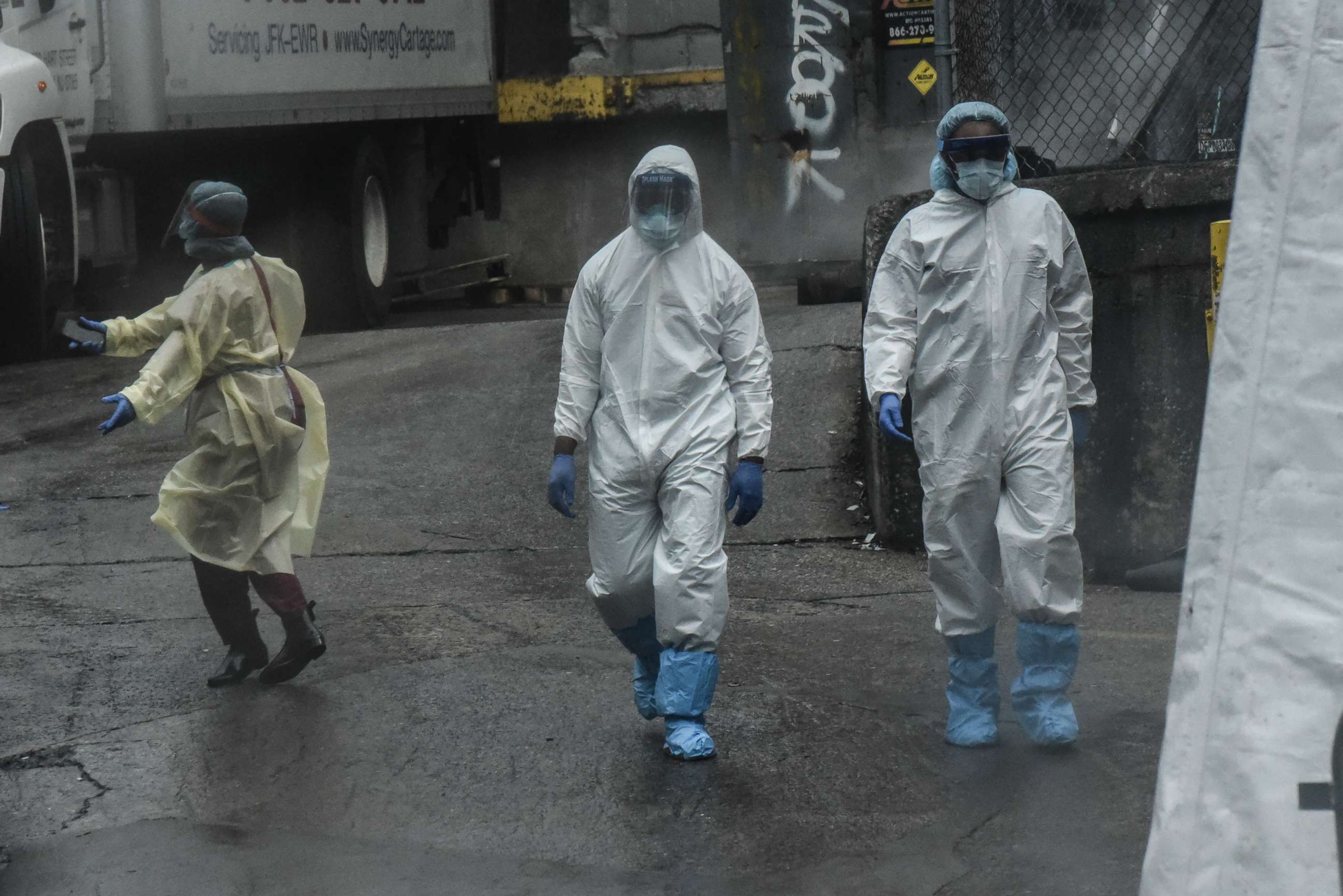 PHOTO: Medical workers approach a refrigerator truck being used as a morgue outside of Brooklyn Hospital Center amid the coronavirus pandemic on April 3, 2020, in New York.