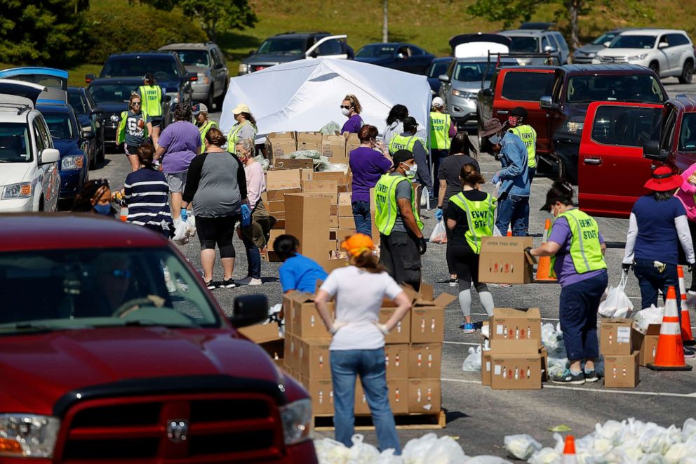 PHOTO: Volunteers load food into vehicles during a mobile market day at Atlanta Motor Speedway on April 17, 2020, in Hampton, Ga.