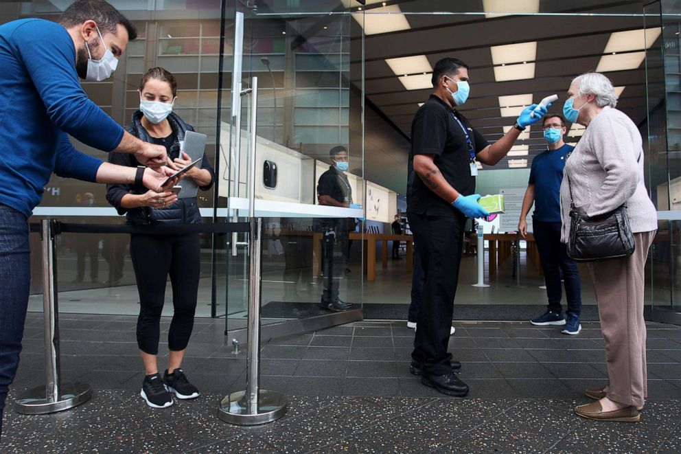 PHOTO: A customer has her temperature tested prior to entering the Apple Store at Bondi Junction on May 07, 2020, in Sydney.
