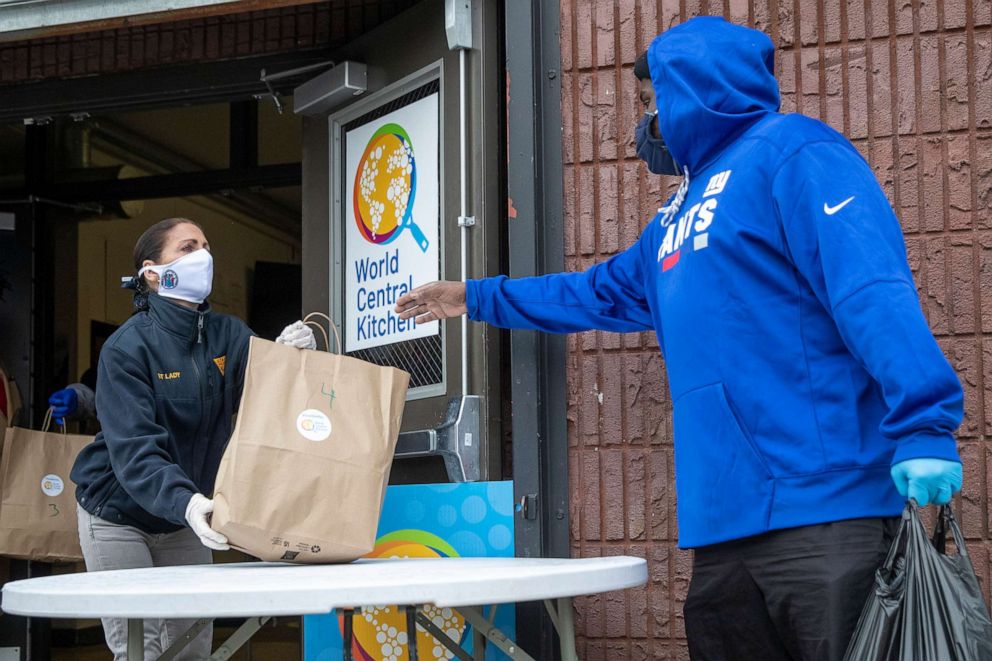 PHOTO: New Jersey first lady Tammy Murphy, left, distributes bags containing meals and face masks, Wednesday, May 6, 2020, at the NAN Newark Tech World in Newark, N.J.