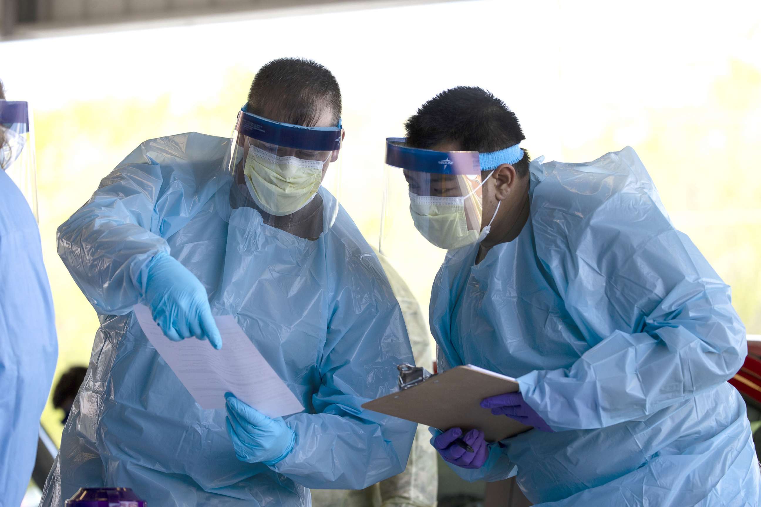 PHOTO: Medical personnel work at a drive thru coronavirus (covid-19) testing site at Robertson County Fairgrounds, April 18, 2020, in Springfield, Tenn.