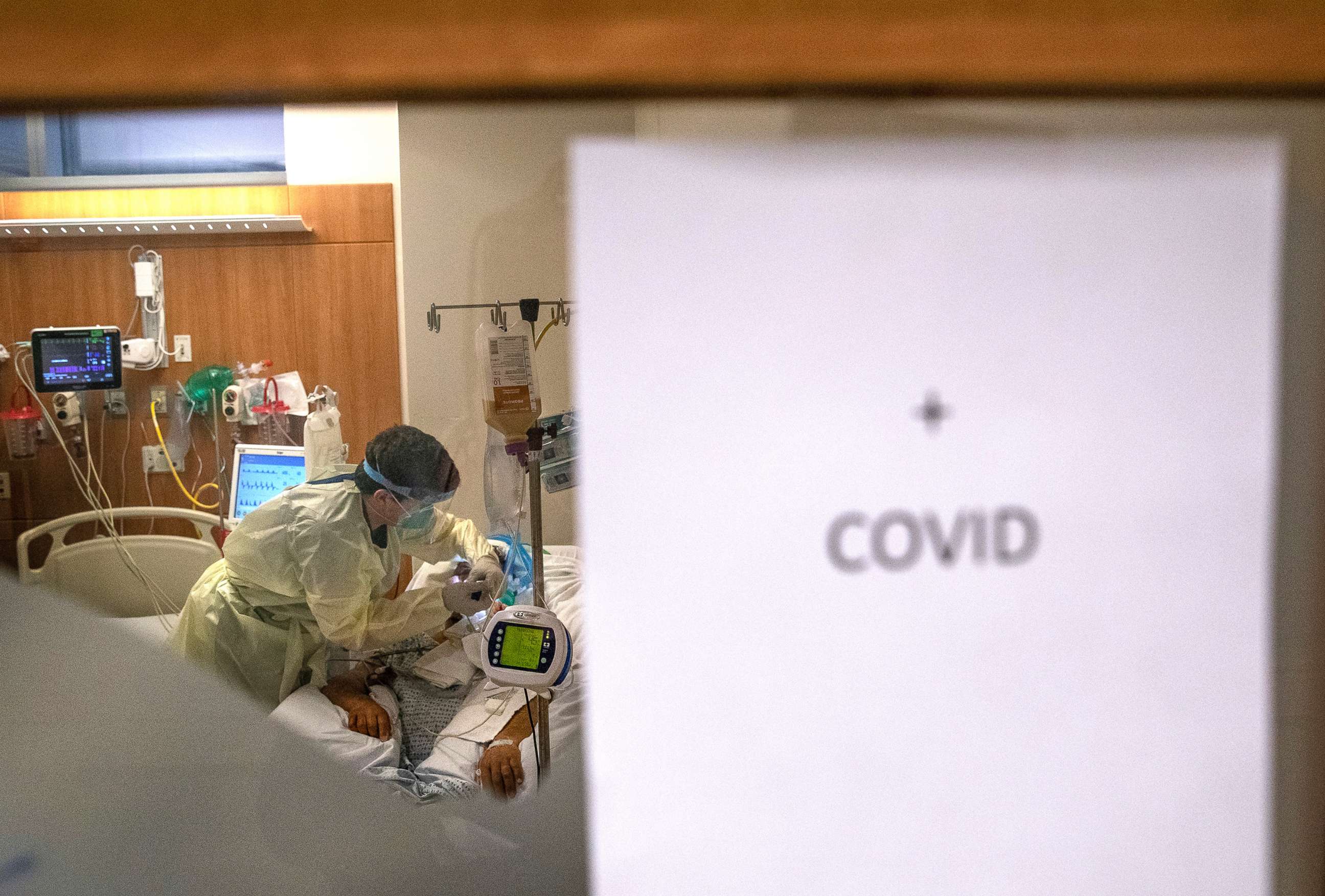 PHOTO: A nurse wearing personal protective equipment (PPE), tends to a COVID-19 patient in a Stamford Hospital intensive care unit (ICU), April 24, 2020 in Stamford, Conn.