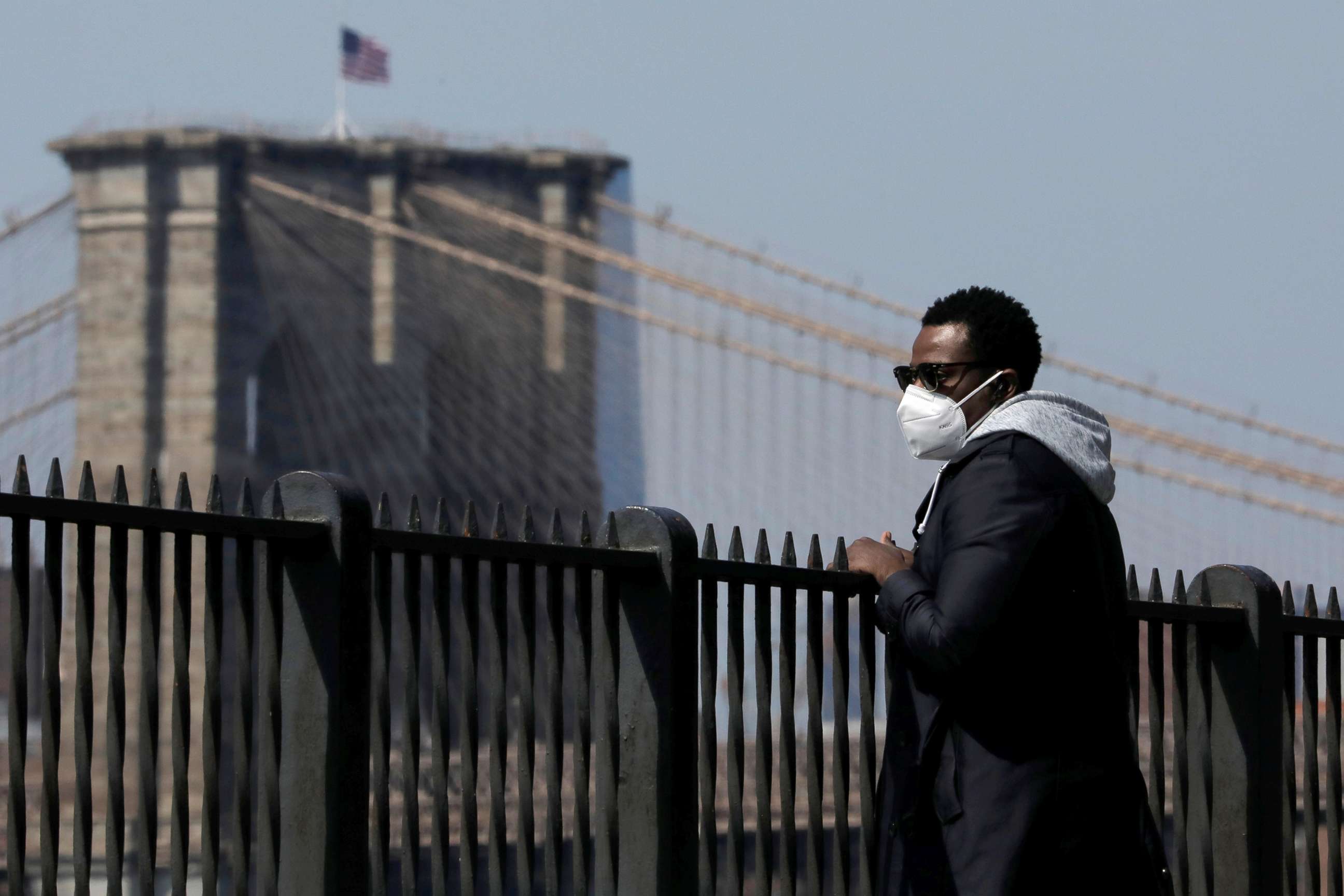 PHOTO: A man wearing a face mask looks toward Brooklyn Bridge from the Brooklyn Heights Promenade during the outbreak of the coronavirus disease (COVID-19) in Brooklyn, New York, April 19, 2020. 
