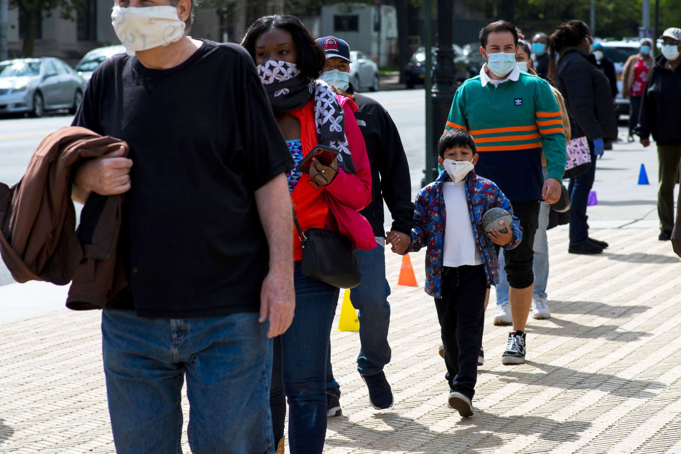 PHOTO: People queue to get free masks distributed by Urban Park Rangers at Grand Army Plaza, during the outbreak of the coronavirus disease (COVID-19) in Brooklyn, New York, May 3, 2020. 