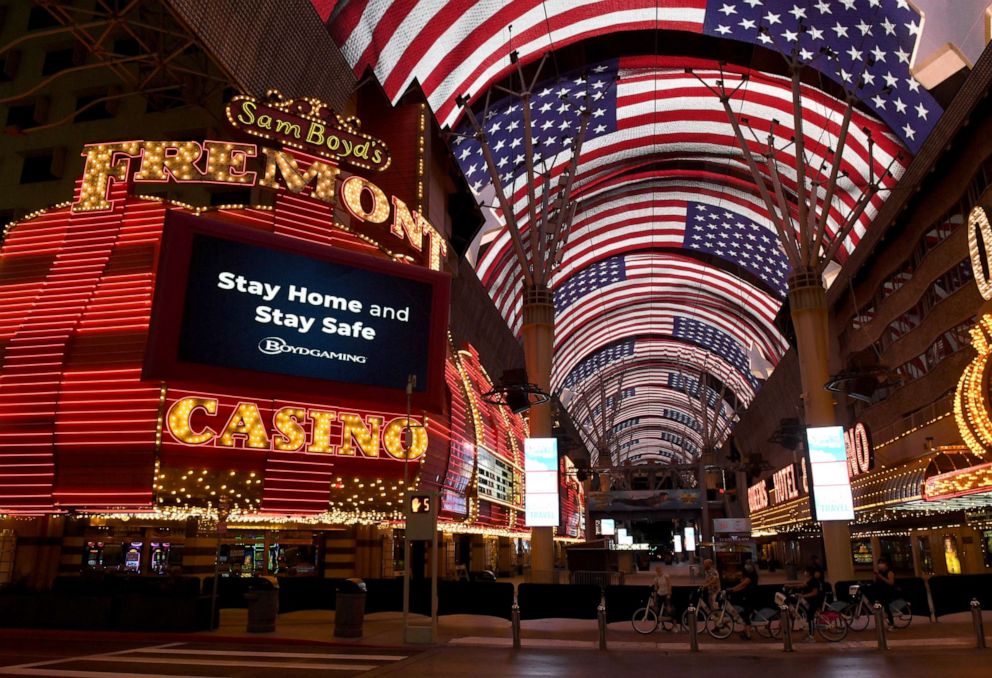 PHOTO: Bicyclists stop on Casino Center Boulevard in front of the closed Fremont Hotel & Casino amid the spread of the coronavirus on May 5, 2020, in Las Vegas.