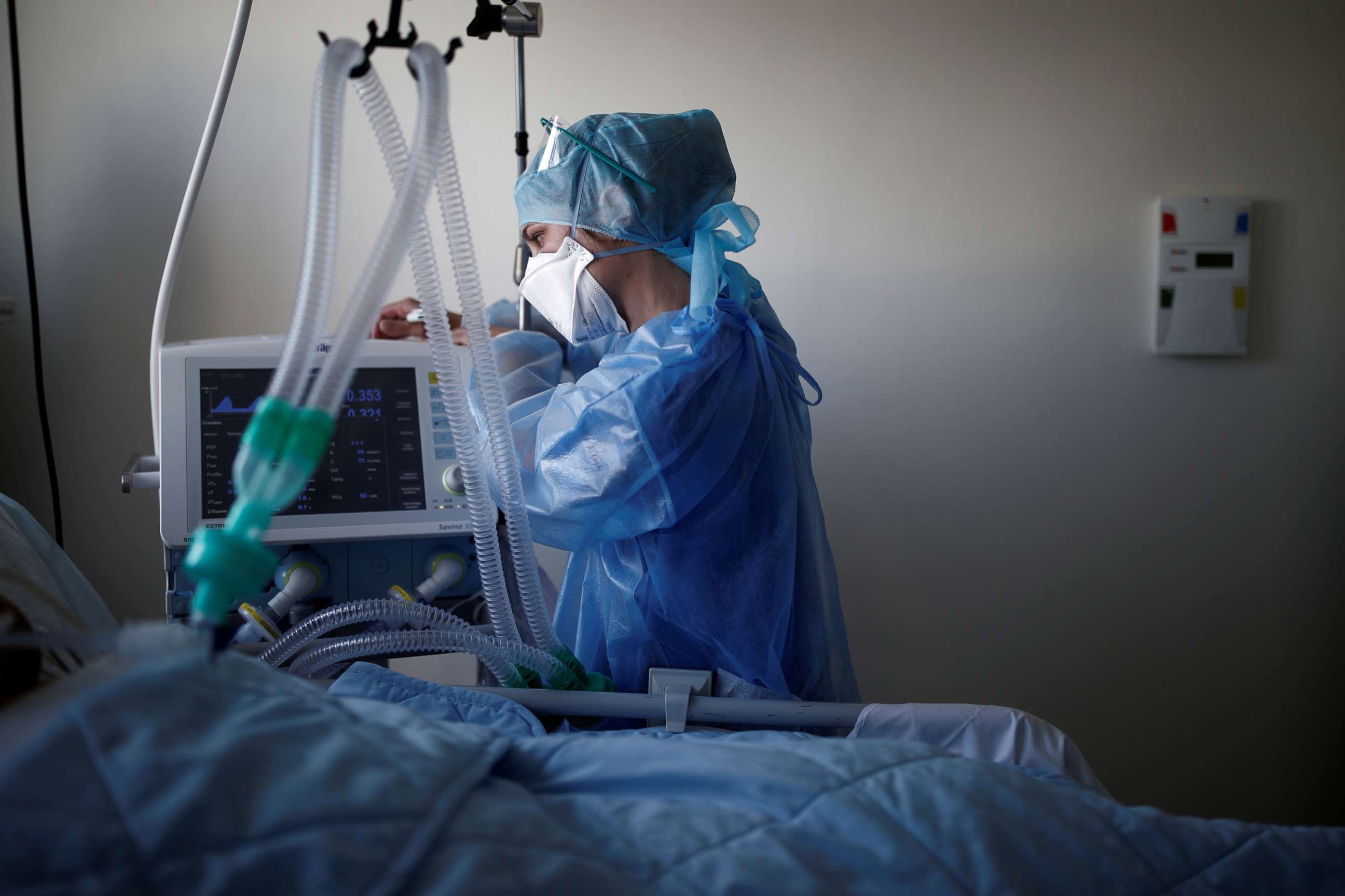 PHOTO: Nurse Samantha Poirier, 28-year-old, checks an artificial respirator as she treats a patient suffering from coronavirus disease (COVID-19) in the Intensive Care Unit at the Clinique de l'Estree private hospital in Stains, France, April 20, 2020. 