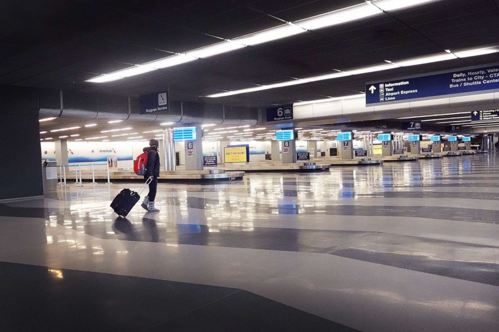 PHOTO: A traveler arrives at a nearly-deserted O'Hare International Airport on April 2, 2020, in Chicago.