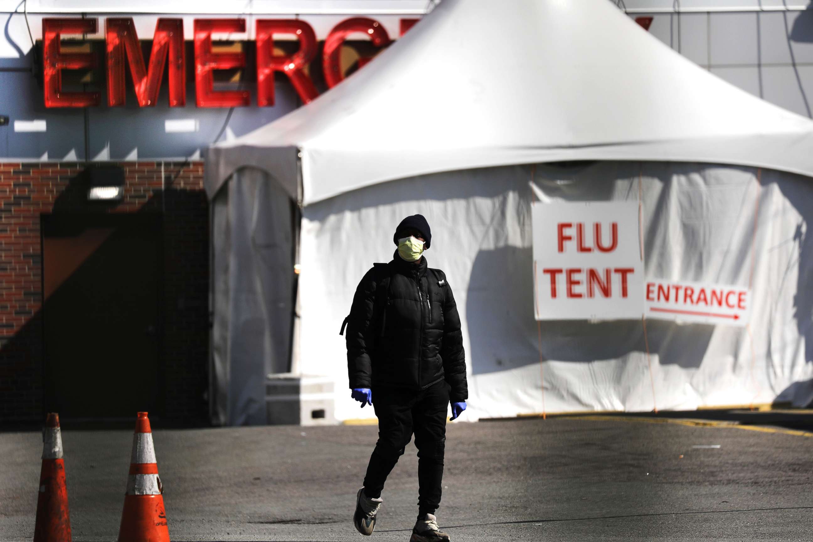 PHOTO: People walk by a special coronavirus intake tent at Kingsbrook Jewish Medical Center in Brooklyn, April 19, 2020, in New York.