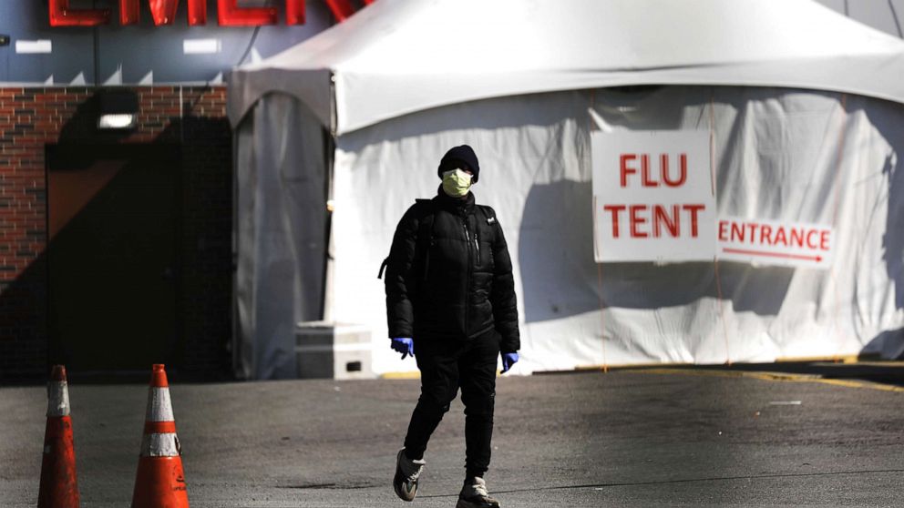 PHOTO: People walk by a special coronavirus intake tent at Kingsbrook Jewish Medical Center in Brooklyn, April 19, 2020, in New York.
