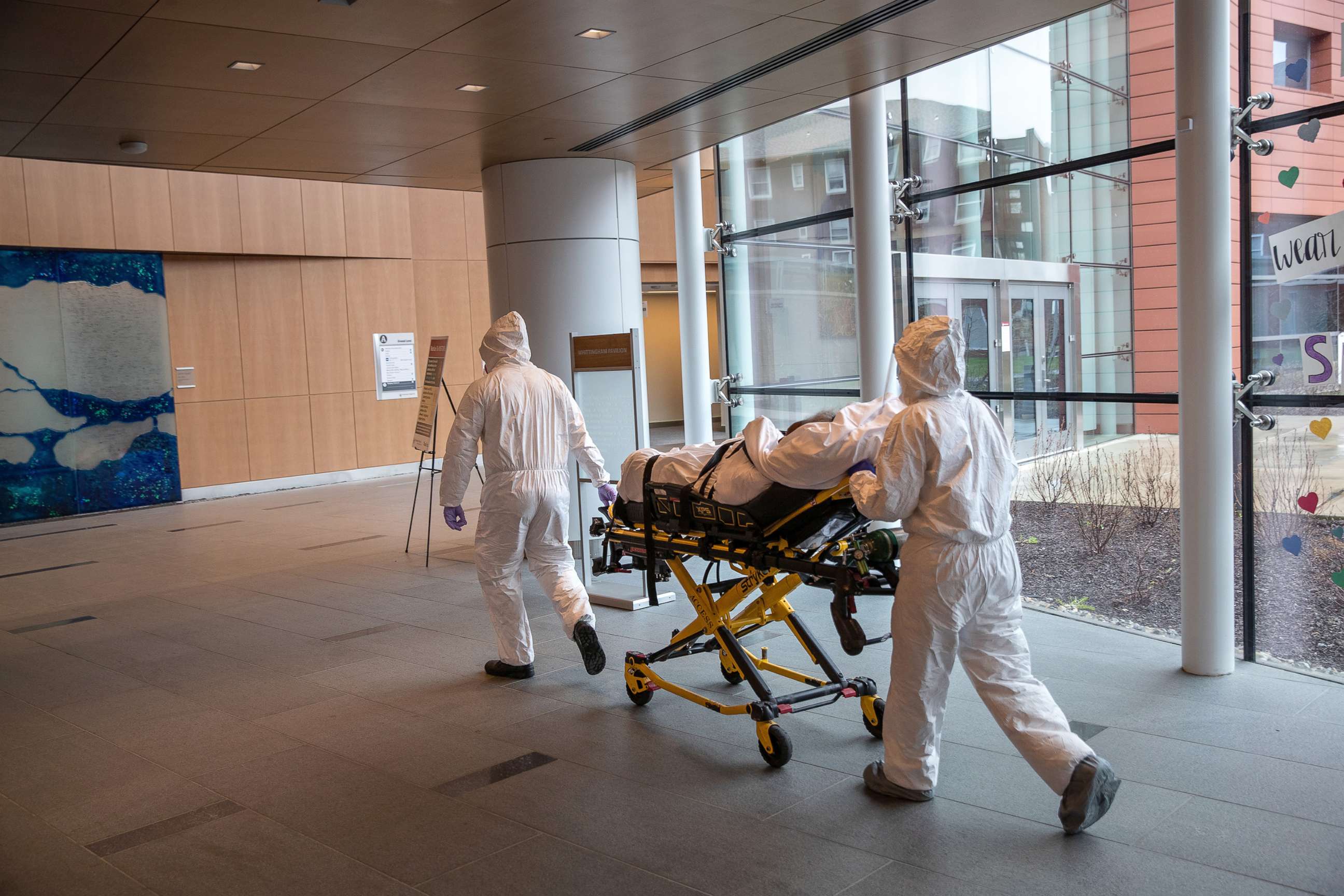 PHOTO: Medical staff wearing personal protective equipment (PPE) transport a COVID-19 patient at Stamford Hospital, April 24, 2020, in Stamford, Conn.