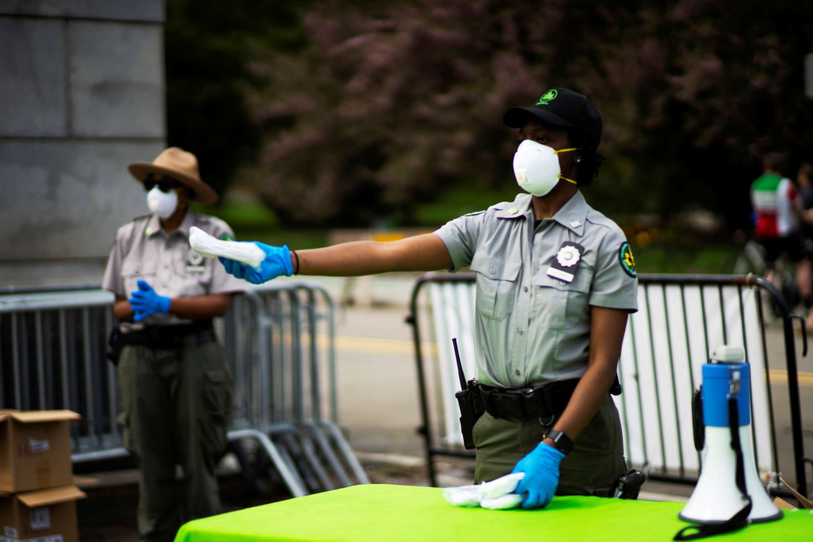 PHOTO: Park Rangers distribute free masks to people at Grand Army Plaza, during the outbreak of  coronavirus in the Brooklyn, New York.