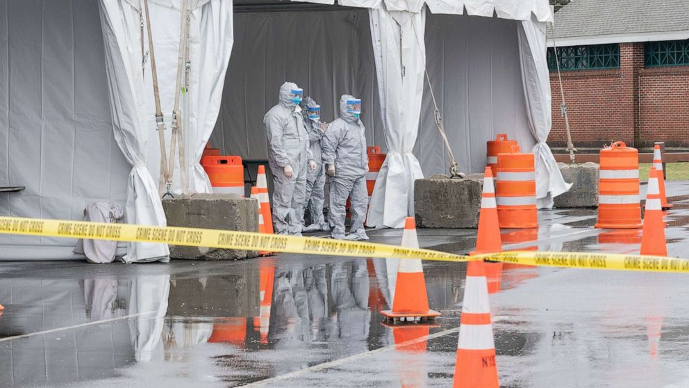 PHOTO:Workers in protective gear operate a drive through coronavirus mobile testing center organized by Northwell hospital at Glen Island Park in New Rochelle, New York, March 13, 2020.