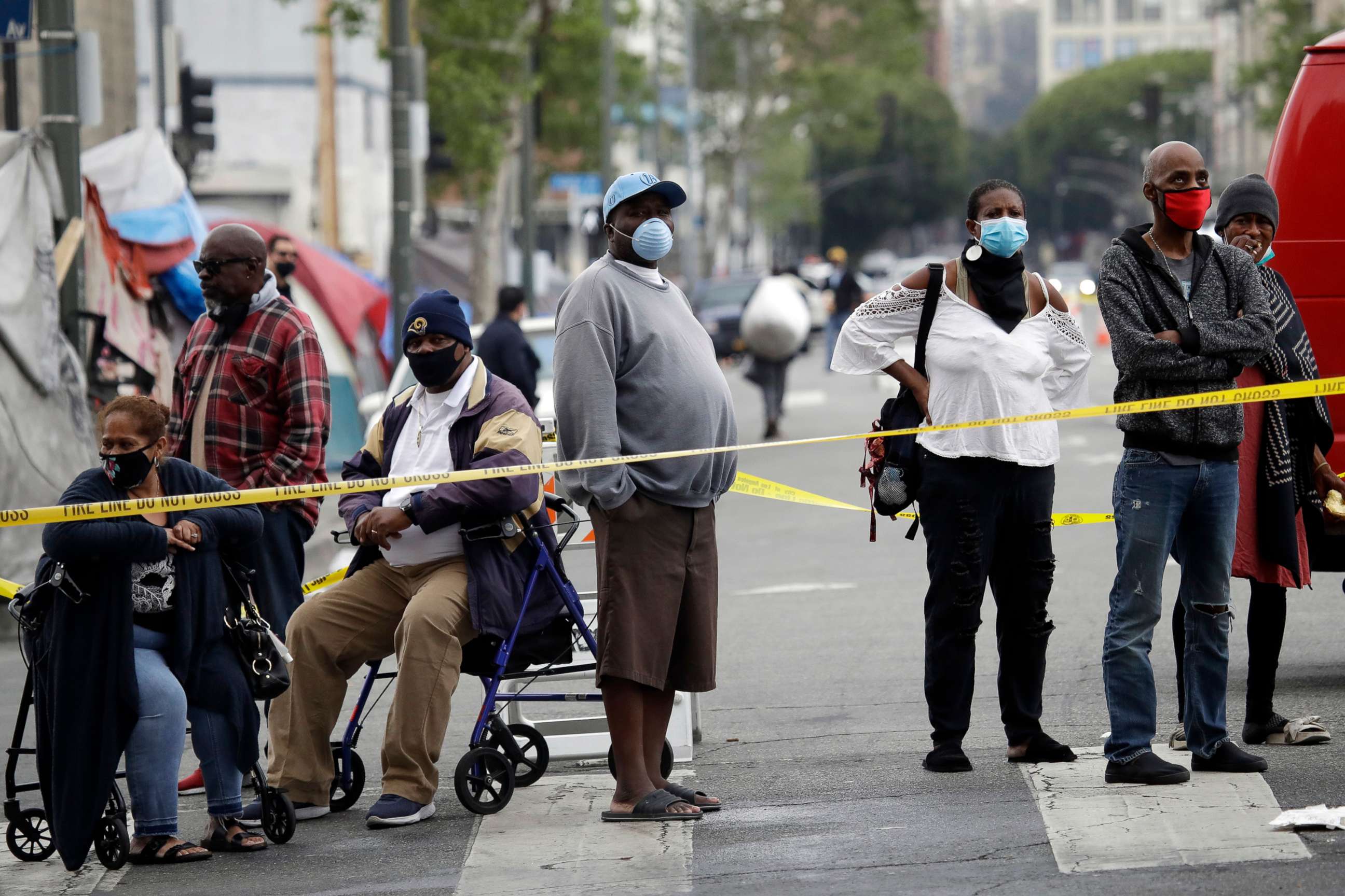 PHOTO: People line up to get tested for COVID-19 in the Skid Row district, April 20, 2020, in Los Angeles. 